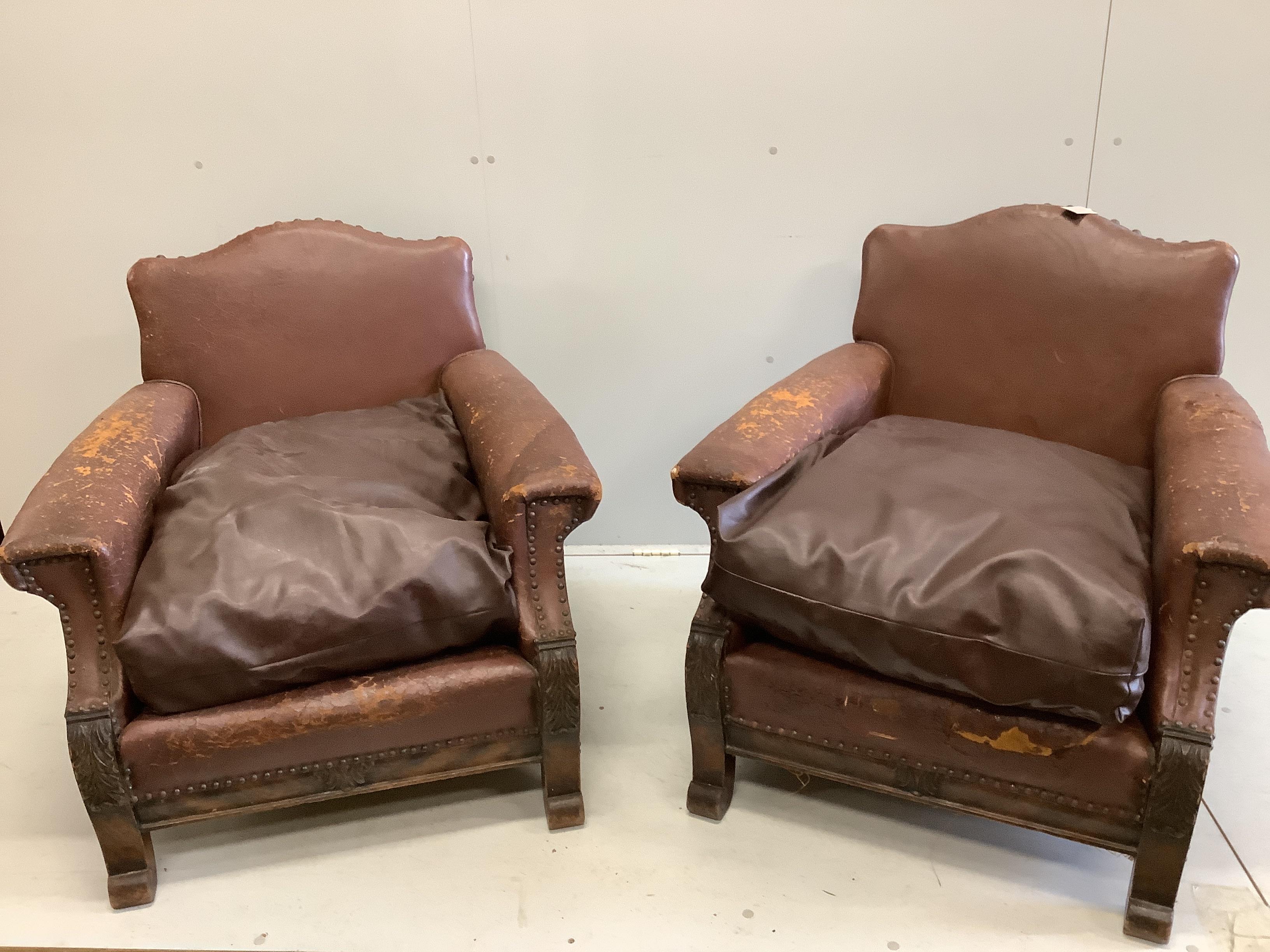 A pair of early 20th century French brown leather studded club chairs, width 84cm, depth 84cm, height 82cm